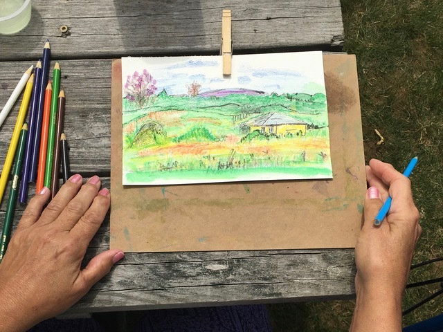 Colored pencil sketch on a board, from the perspective of the artist.
