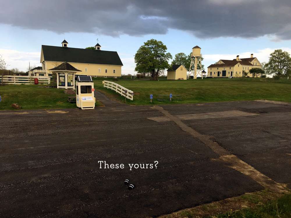 Laudholm campus with parking lot in foreground, showing a pair of abandoned sandals.