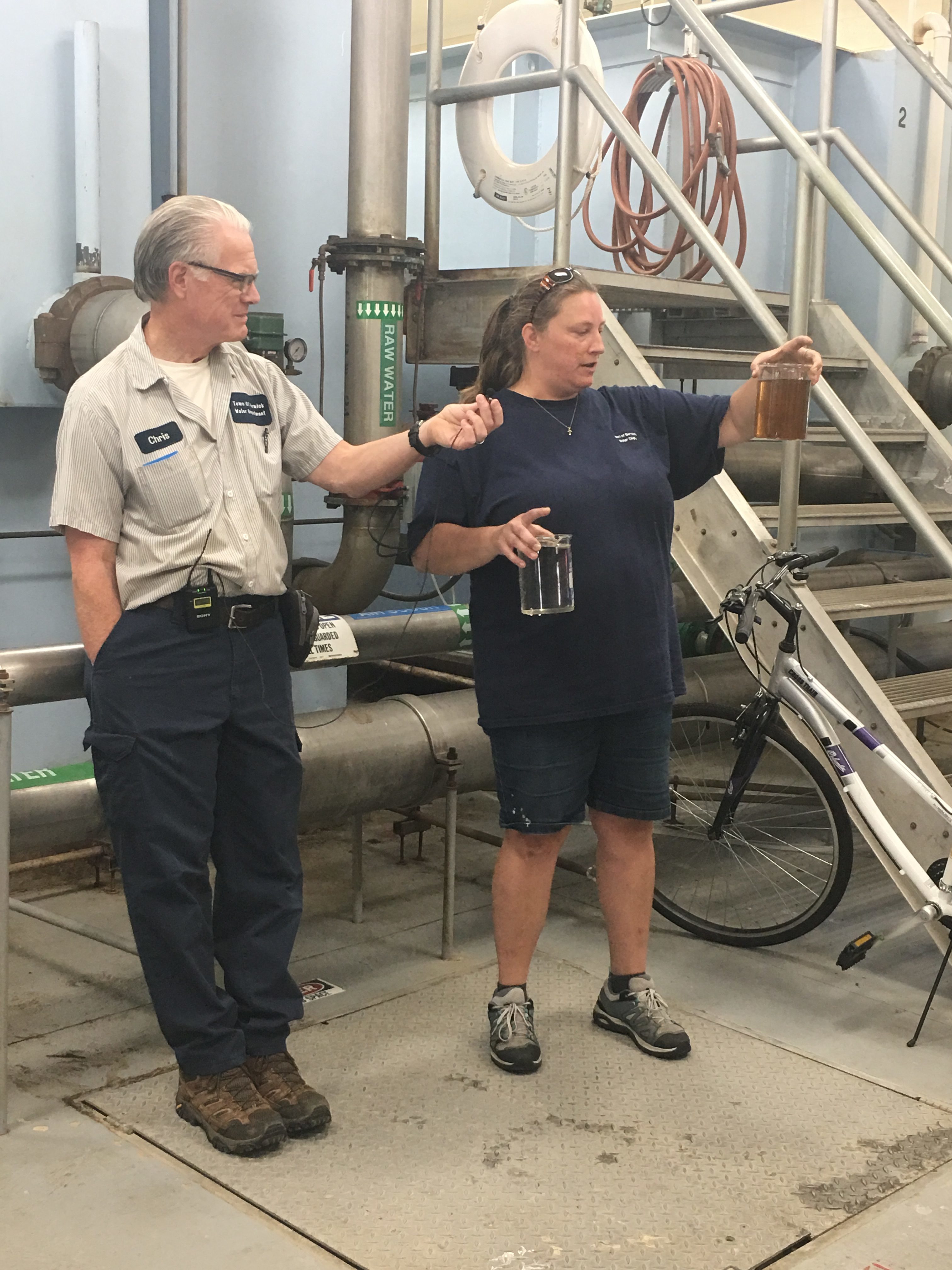 Starr Glenn displays water samples before and after treatment by the Berwick Water Department.