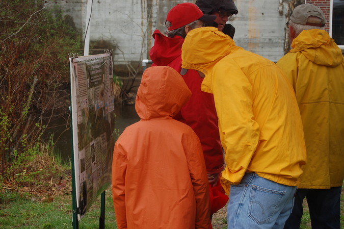Attendees at the dedication ceremony view a poster on the Branch Brook project.