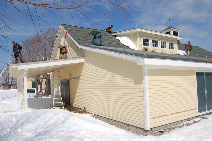 First stage of solar installation: aluminum framework mounted to roof