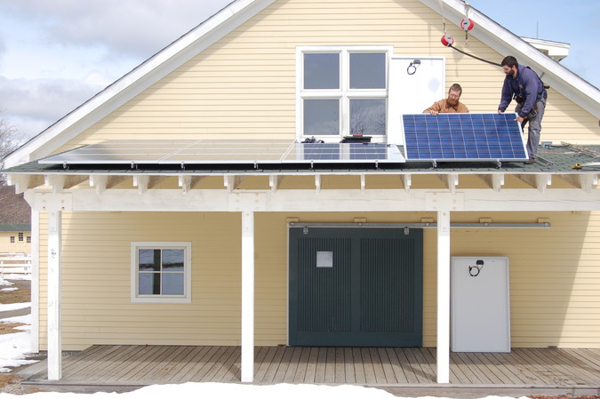 Installing solar panels on the MCEC porch roof
