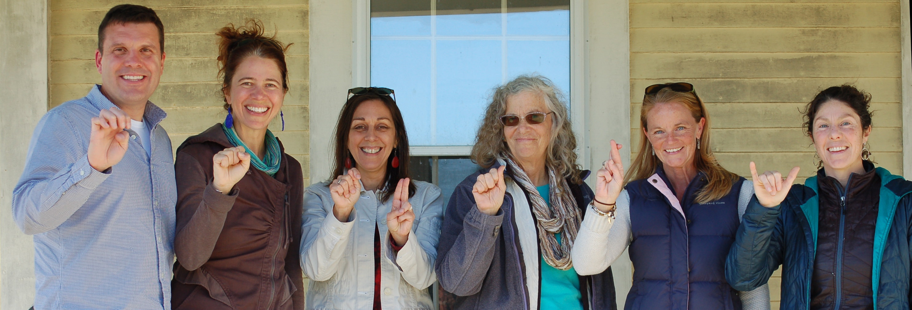 The project team for Watershed Stewardship in Action: Deaf Students on the Estuary fingerspells estuary. Team members are Todd Czubek, Boston University; Suzanne Kahn, Wells Reserve; Jeanne Reis, The Learning Center; Joan Muller, Waquoit Bay Reserve; Maureen Dewire, Narragansett Bay Reserve; and Caryn Beiter, Wells Reserve.
